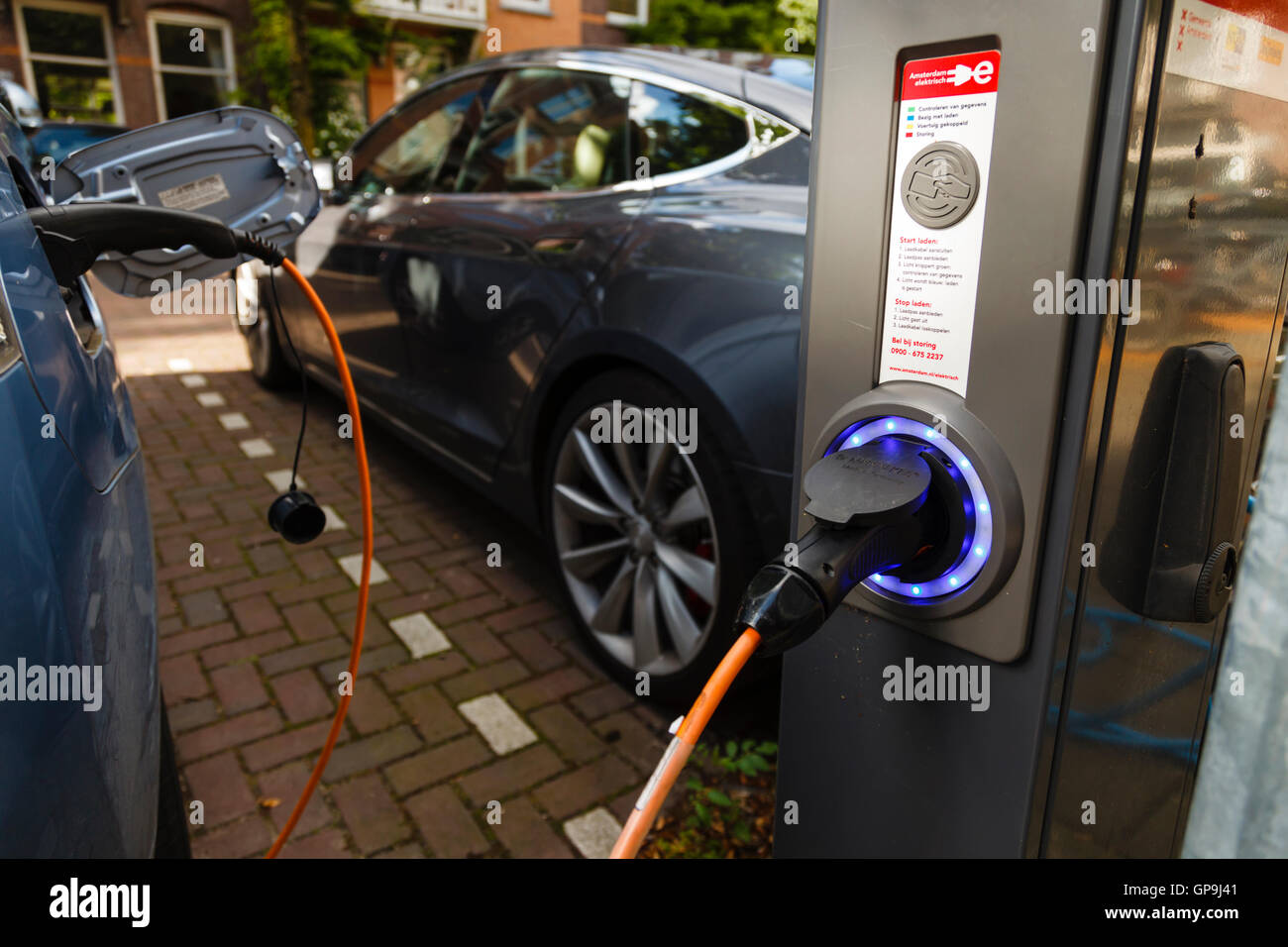Electric cars parked and connected to a charging point in Amsterdam