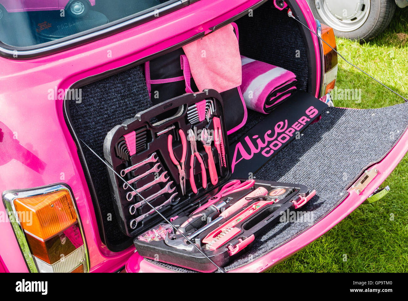 Pink Austin Mini Cooper S, nicknamed 'Alice Cooper' at a Mini Car Owners' Club exhibition with matching accessories in the boot Stock Photo