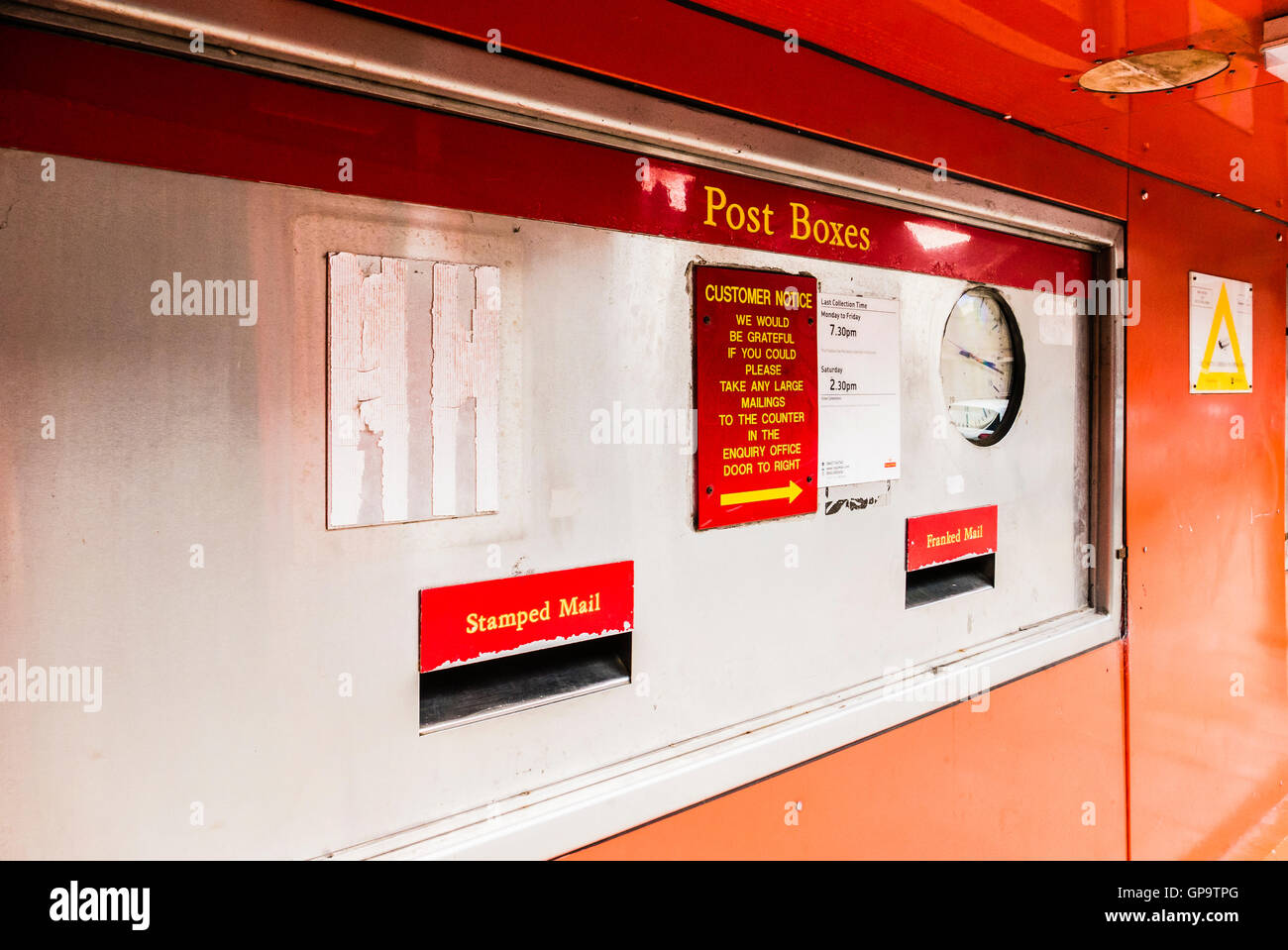 Letter box at a main Royal Mail sorting office, including boxes for franked and stamped post. Stock Photo