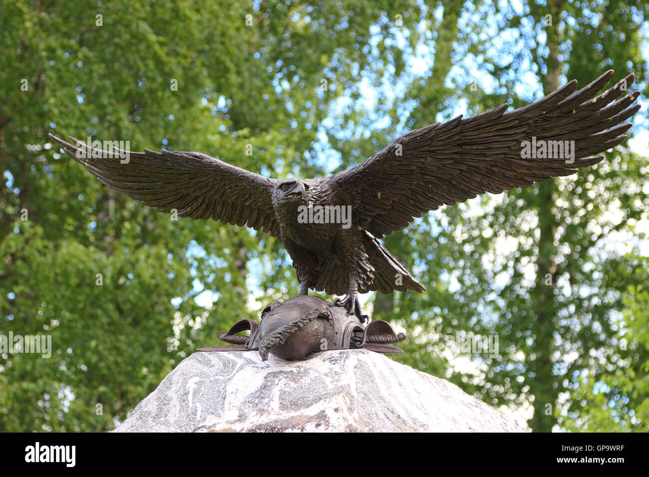 A bronze eagle taking off a stone monument with cuirass of a dead soldier. Russia, Borodino. Stock Photo