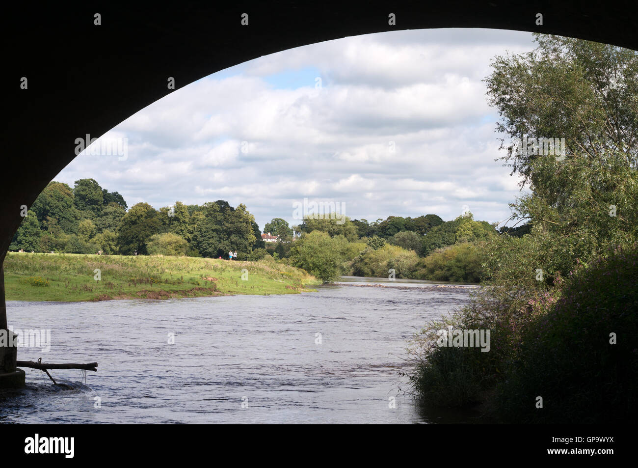 Looking east along the River Eden, framed by an arch of the Eden bridge, Carlisle, Cumbria, England, UK Stock Photo