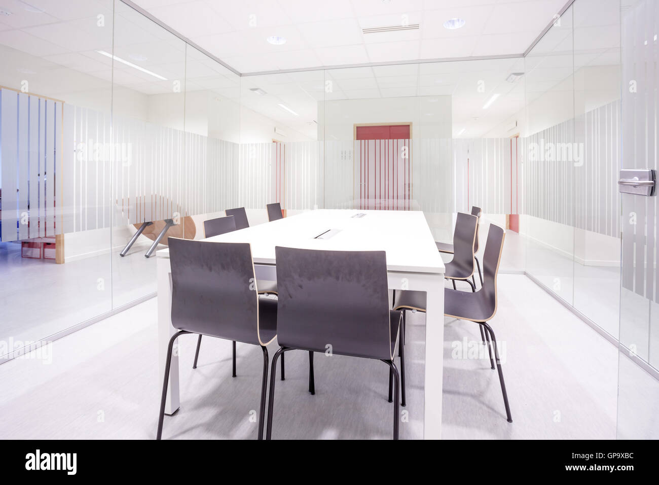 an glass conference room with a table and chairs Stock Photo Alamy