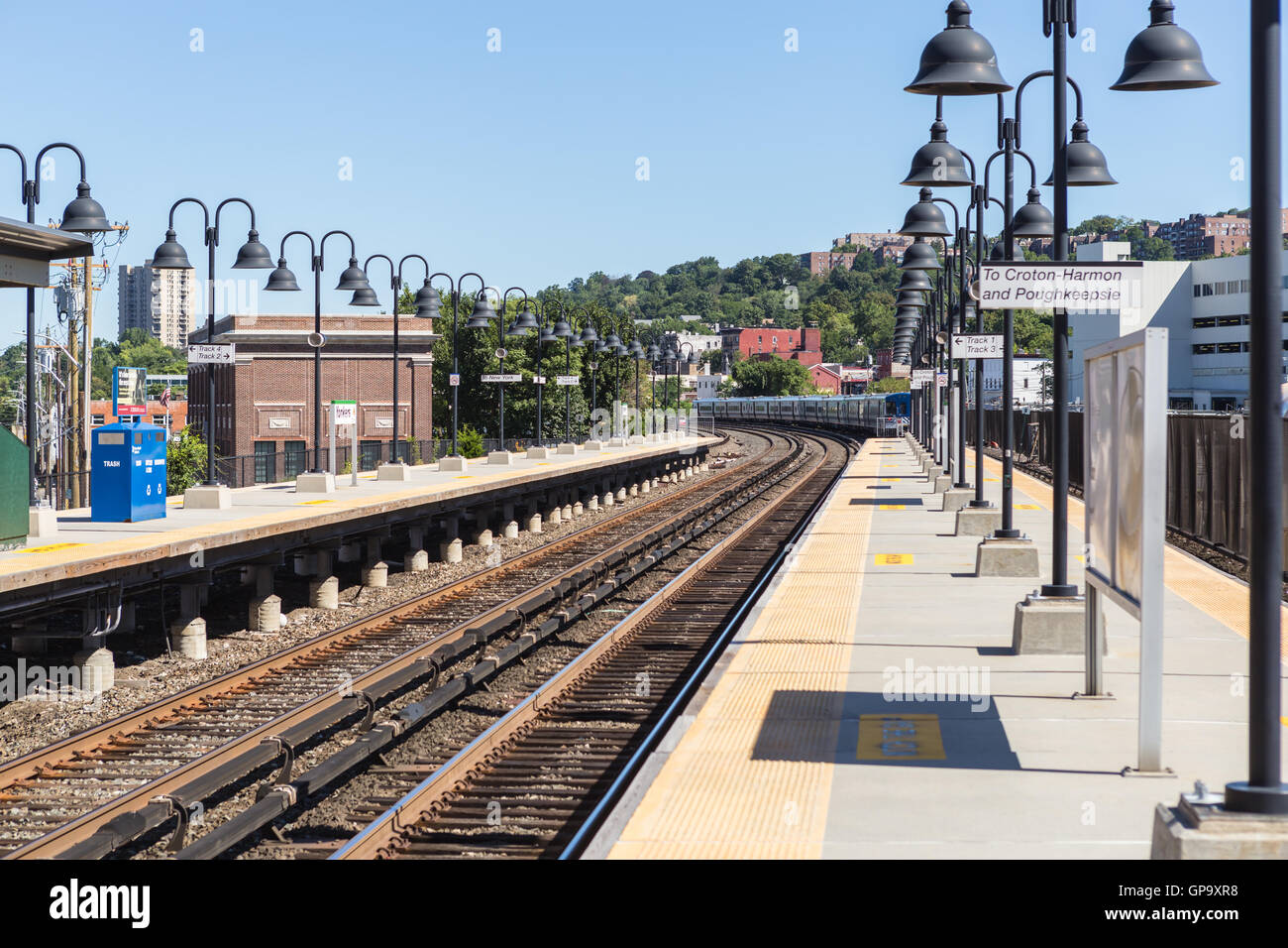 A Metro-North Hudson Line train heading north disappears from sight after leaving  the station in Yonkers, New York. Stock Photo