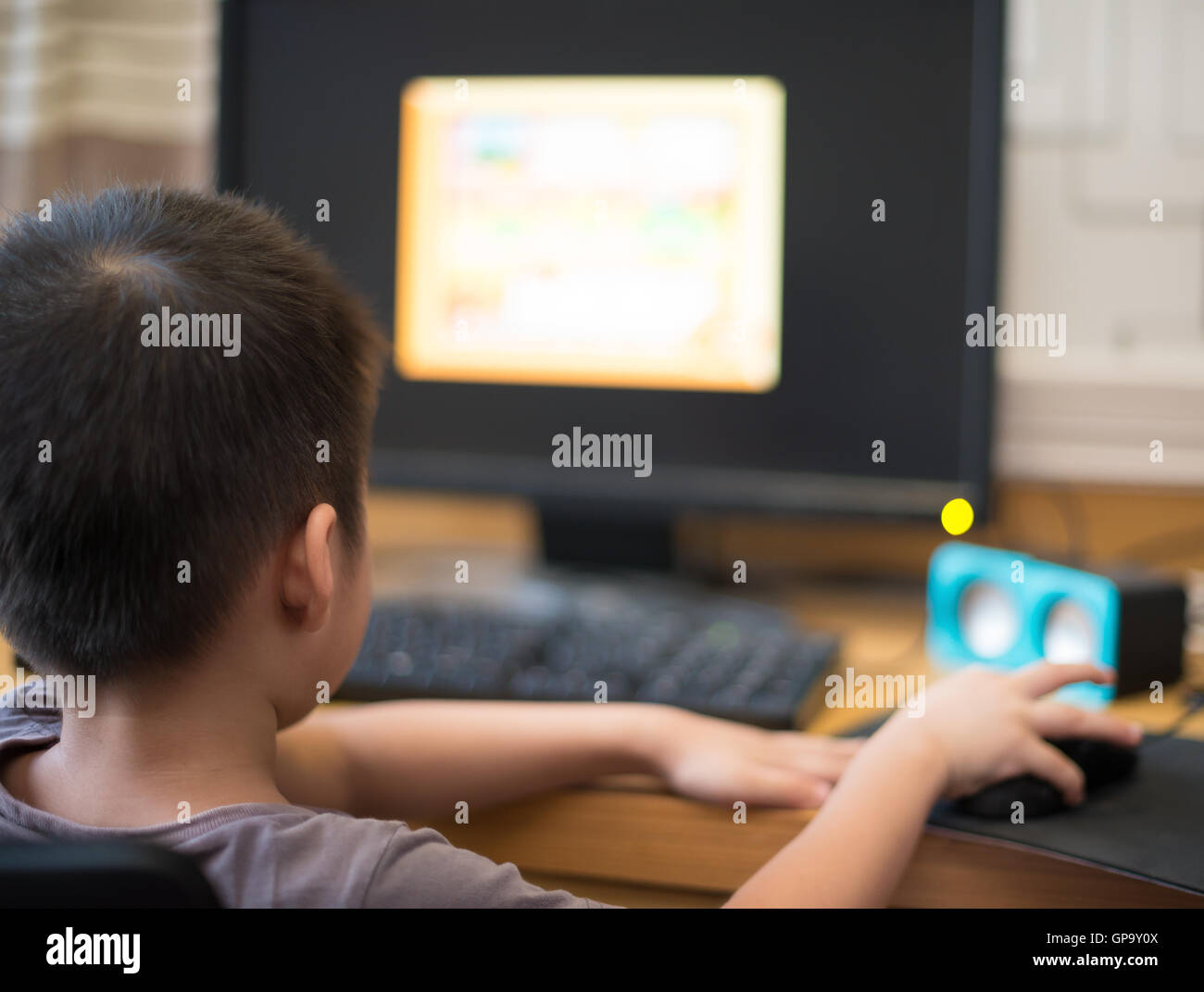 kid playing a computer game for children at home Stock Photo