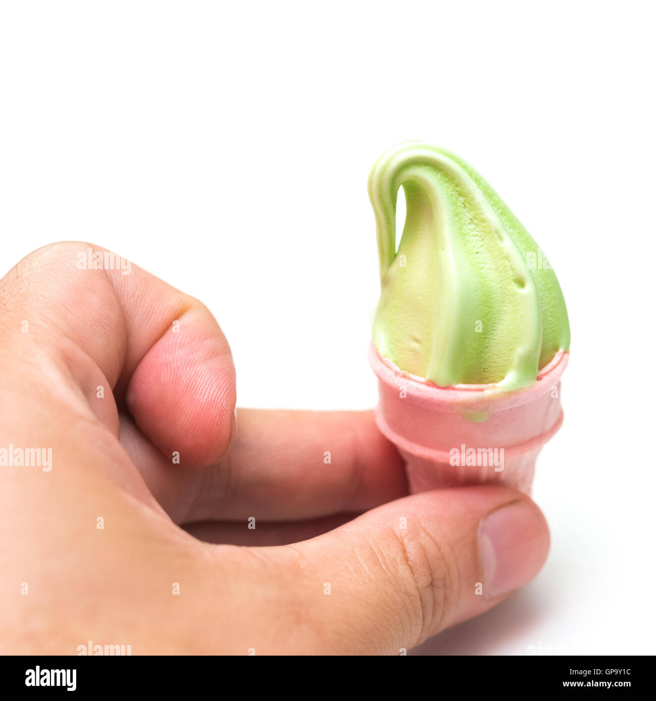fingers catching a mini ice cream on white Stock Photo
