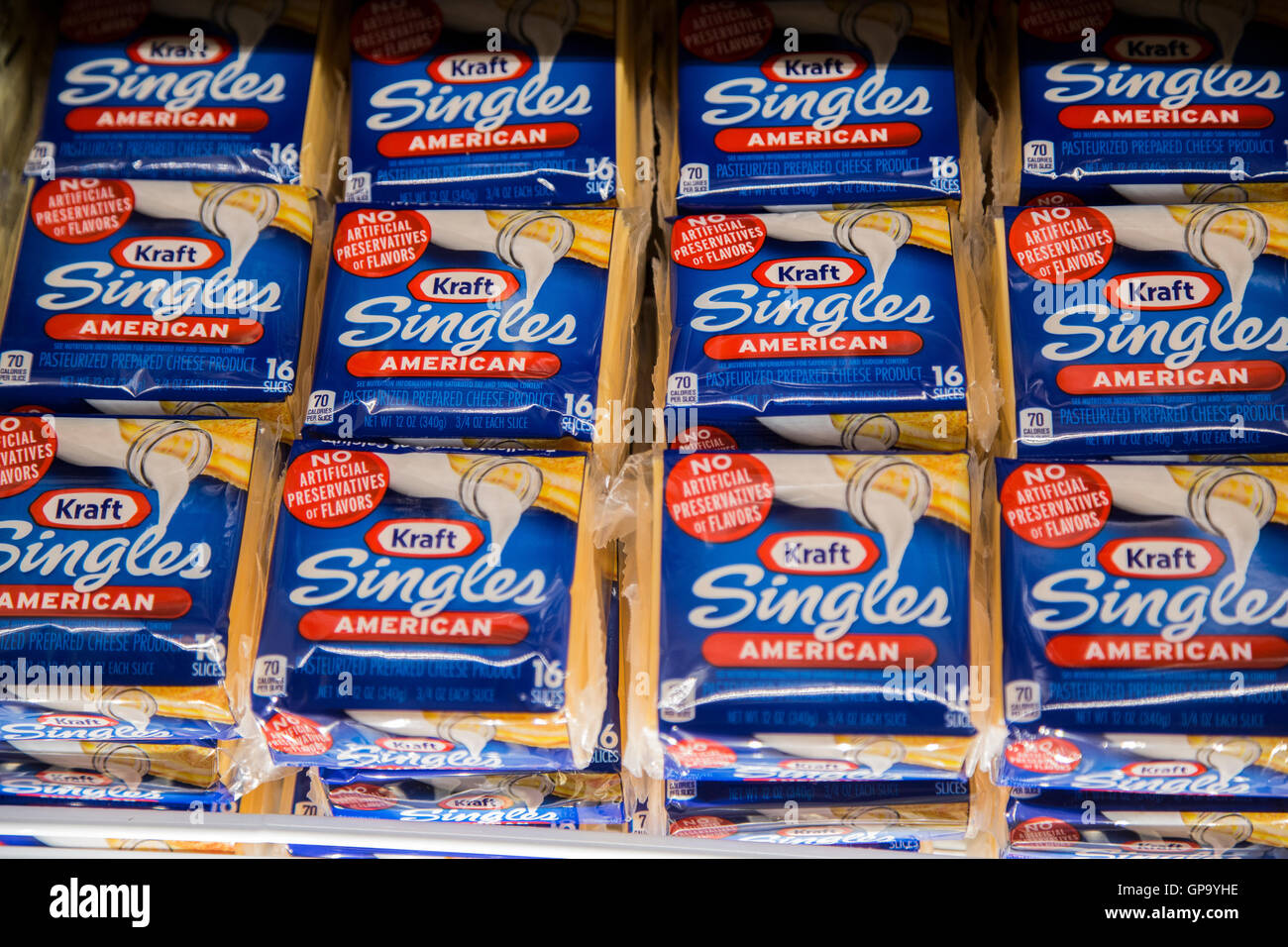 Kraft Singles American cheese packages on display in the refrigerator case at a grocery store Stock Photo