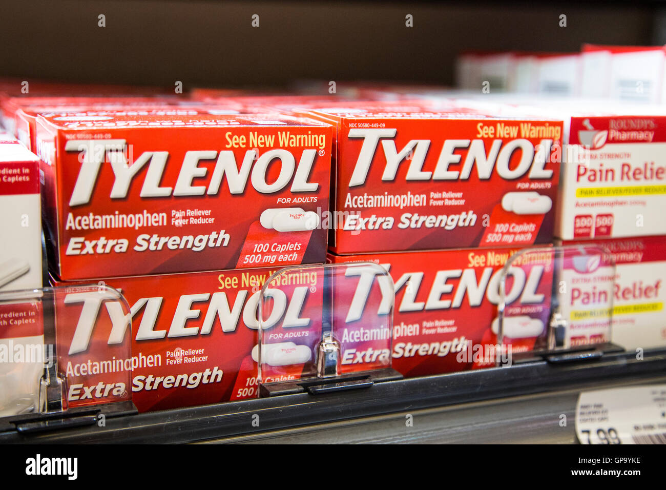 Over the counter pain reliever boxes of Tylenol stacked on a shelf at a