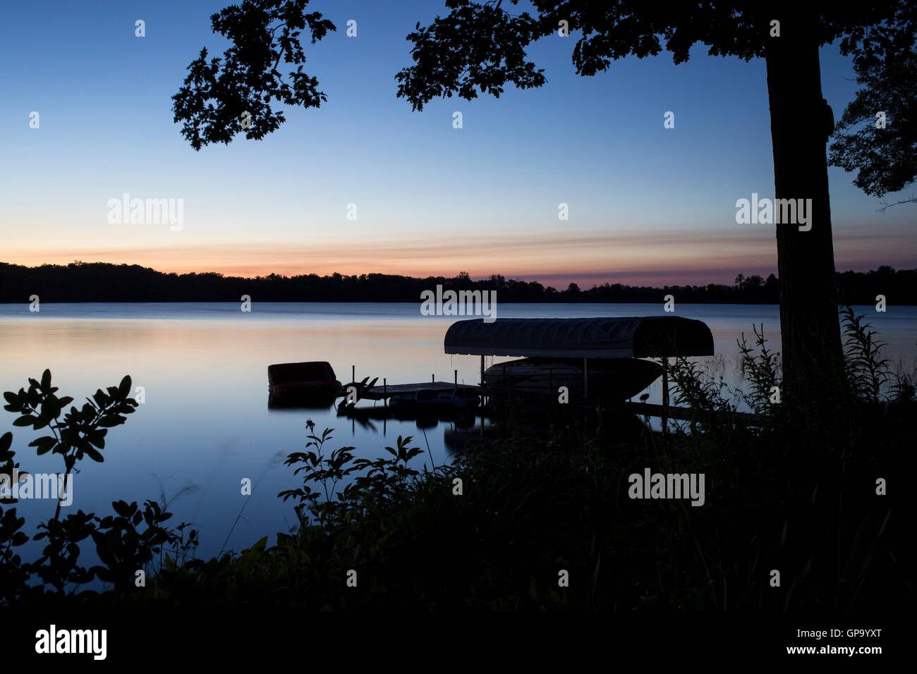 The sun rises over Little Pine Lake near Aitkin, Minnesota, USA August