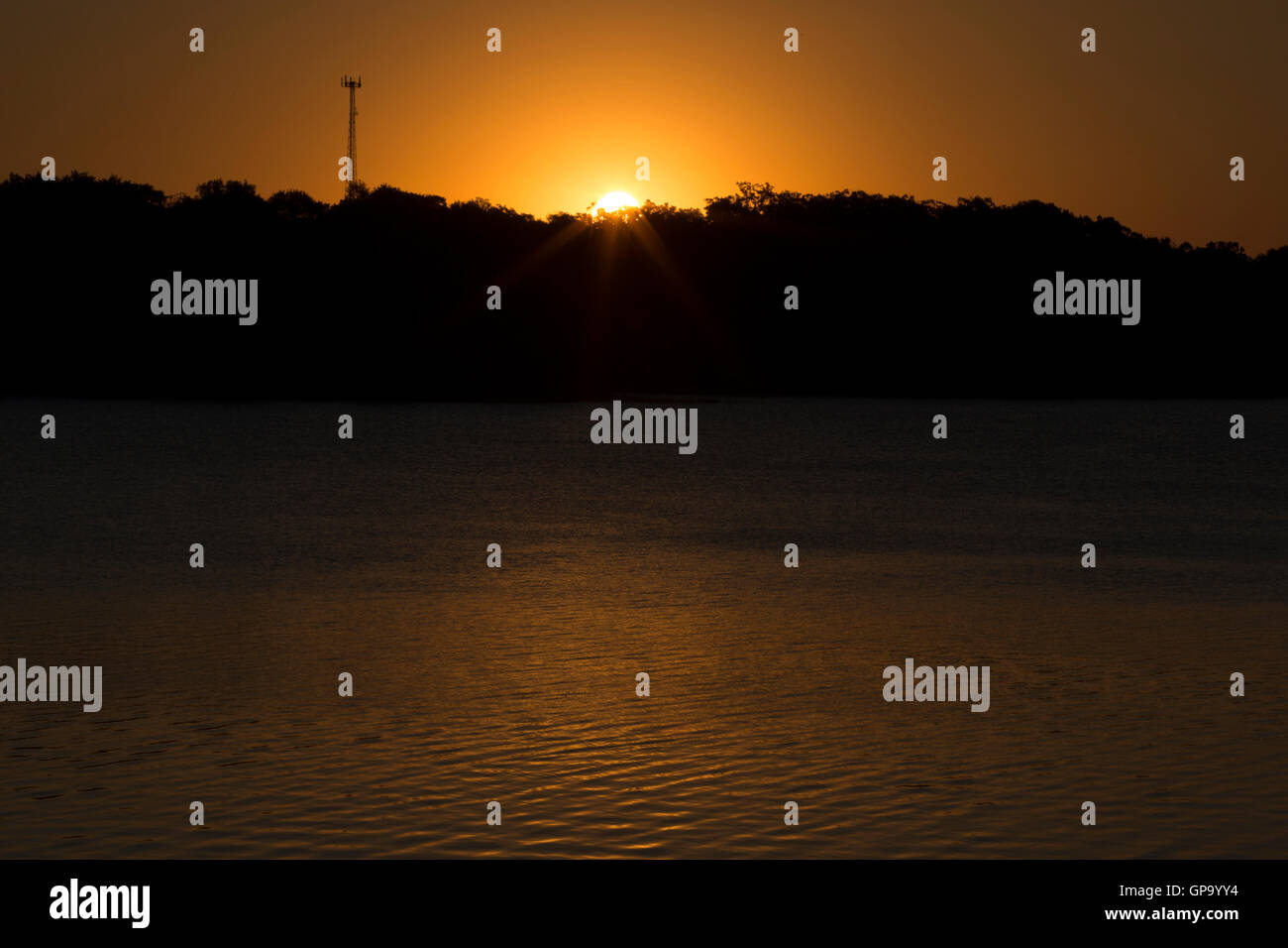 The sun rises over Little Pine Lake near Aitkin, Minnesota, USA August  25, 2016 Stock Photo