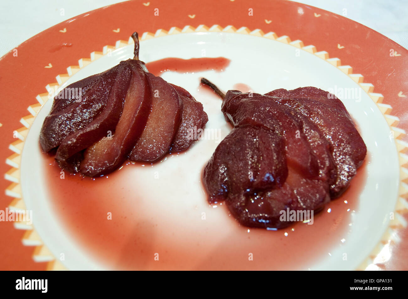 Red wine pears on a dish. Stock Photo