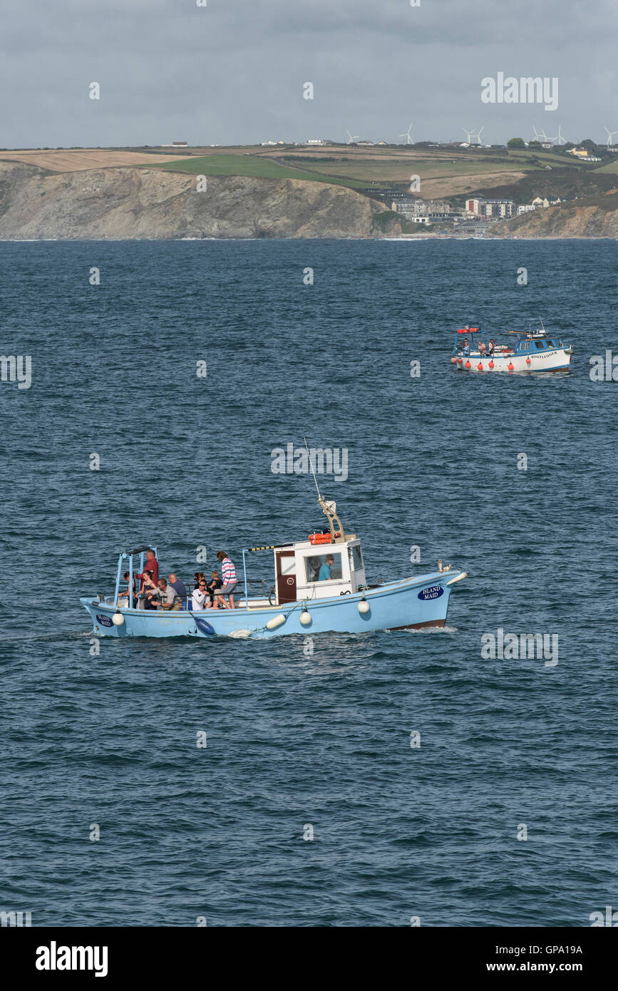 Two pleasure boats full of holidaymakers mackerel fishing in Newquay Bay, Cornwall Stock Photo