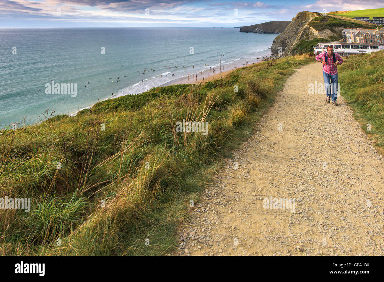 A walker on the South West Coastal Path near Watergate Bay in Cornwall. Stock Photo