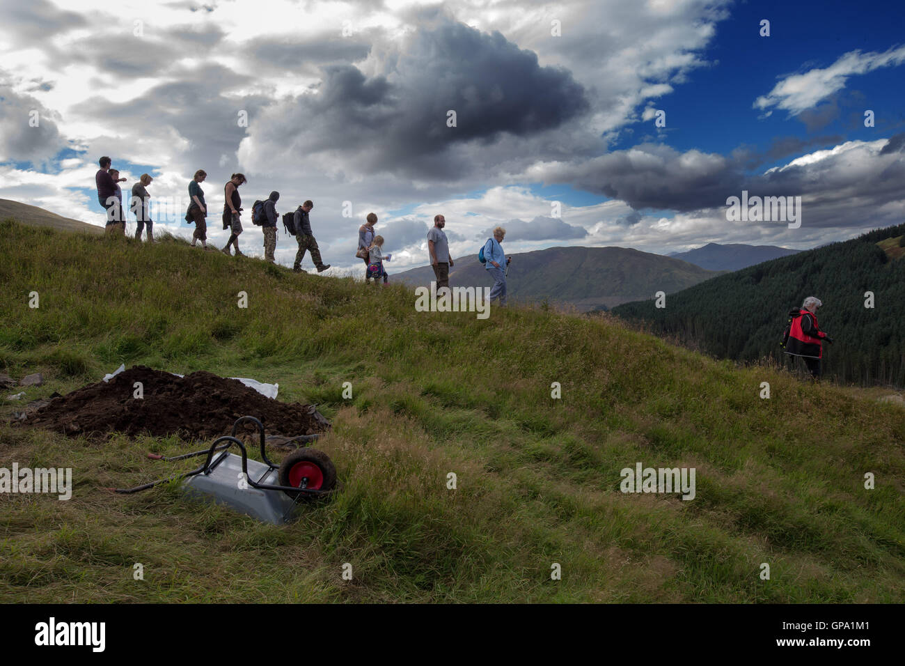 Dun Deardail Archaeological Dig Glen Nevis, Hikers silhouetted against sky Stock Photo