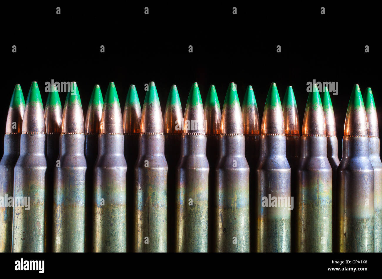 Rifle cartridges with bullets that have a green tip Stock Photo - Alamy