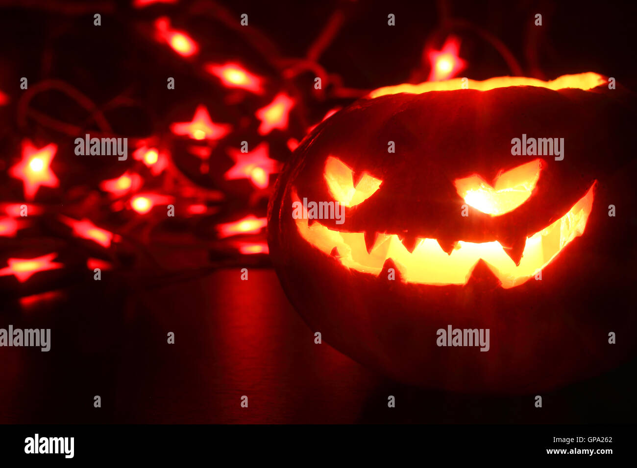 Illuminated cute halloween pumpkin isolated on black background Stock ...