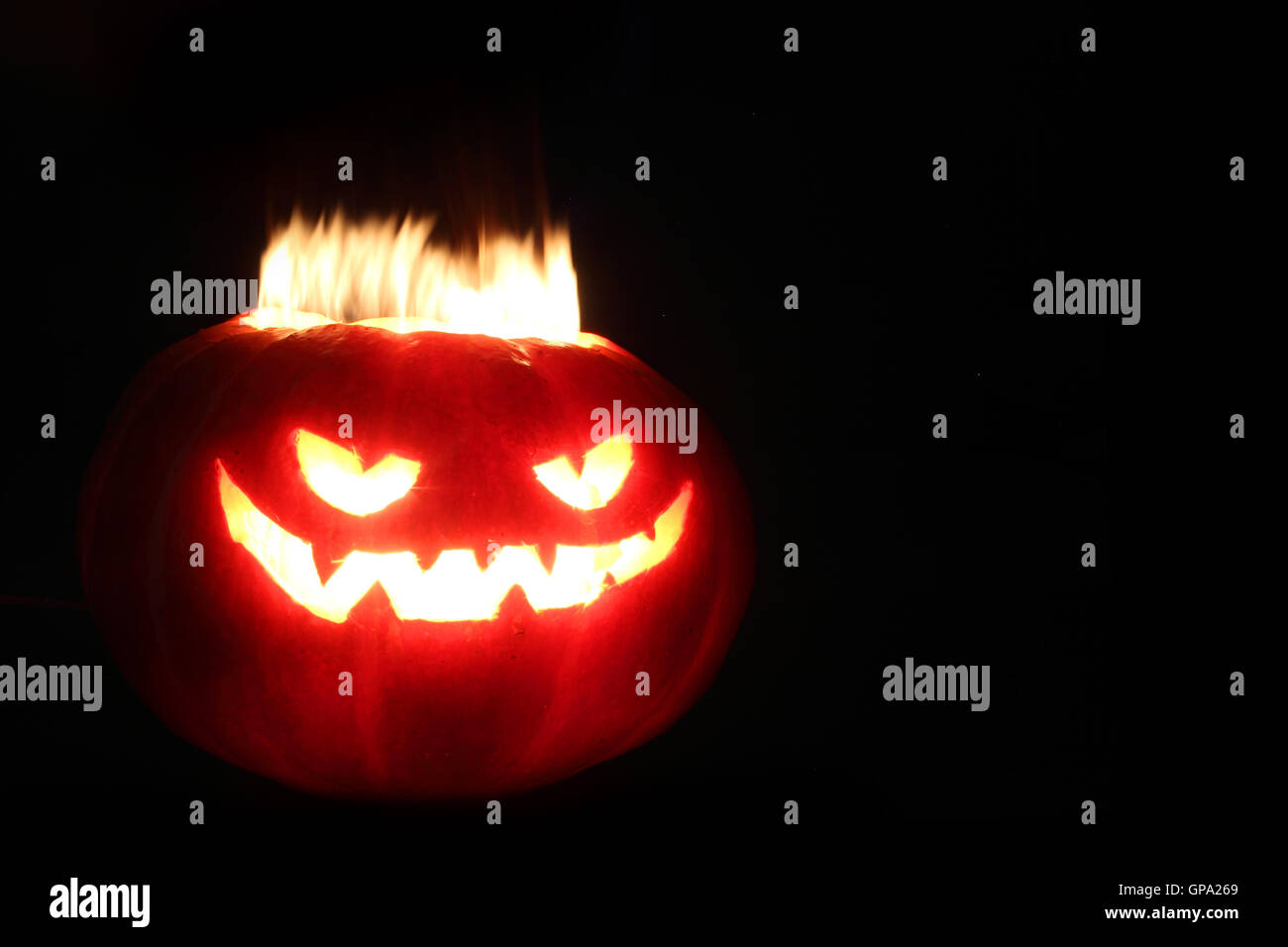 Illuminated cute halloween pumpkin isolated on black background Stock ...