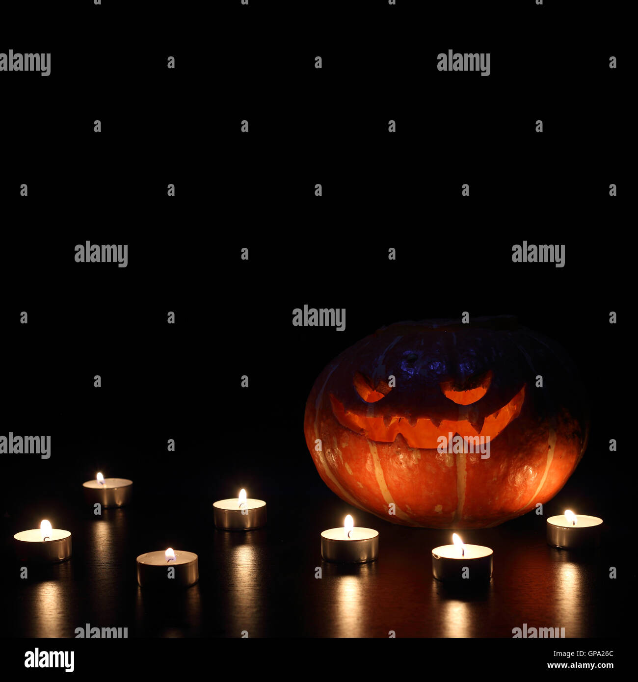 Illuminated cute halloween pumpkin isolated on black background Stock ...