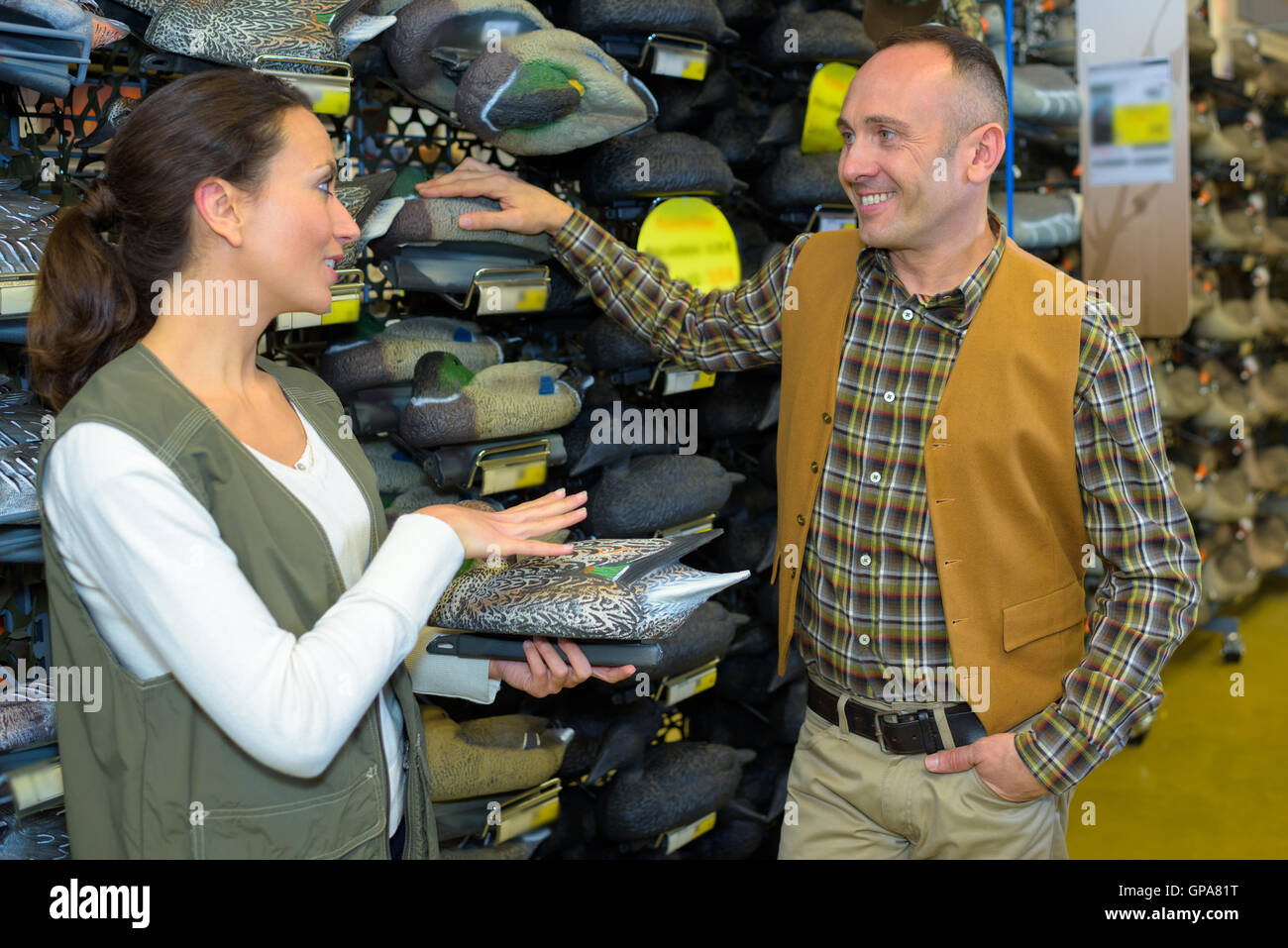 Man and lady in hunting shop Stock Photo - Alamy