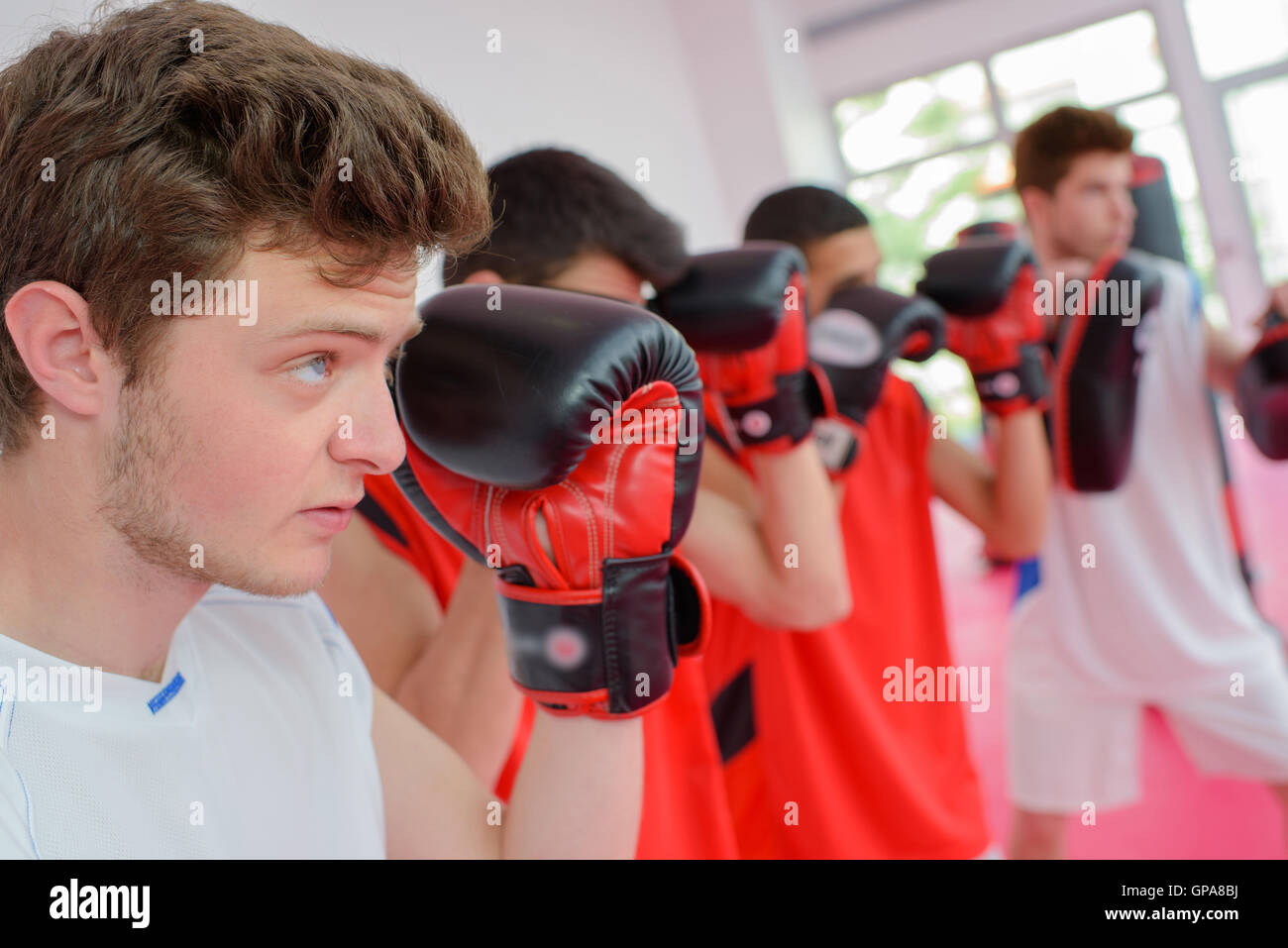 Four men lined up in boxing class Stock Photo Alamy
