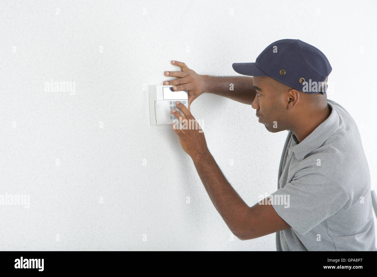 Man fitting switch to wall Stock Photo