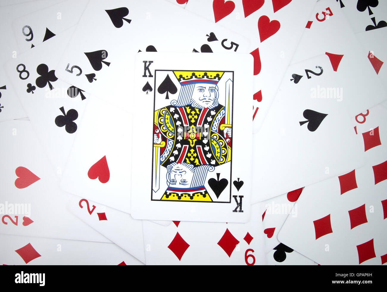 King card with playing cards background Stock Photo - Alamy