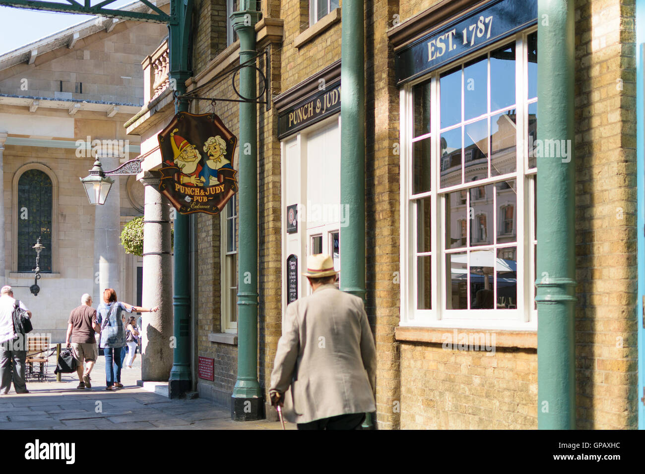 London, England - 30 August 2016: An unidentified man walks pass Punch & Judy pub in Covent Market. The pub was built in 1787 Stock Photo