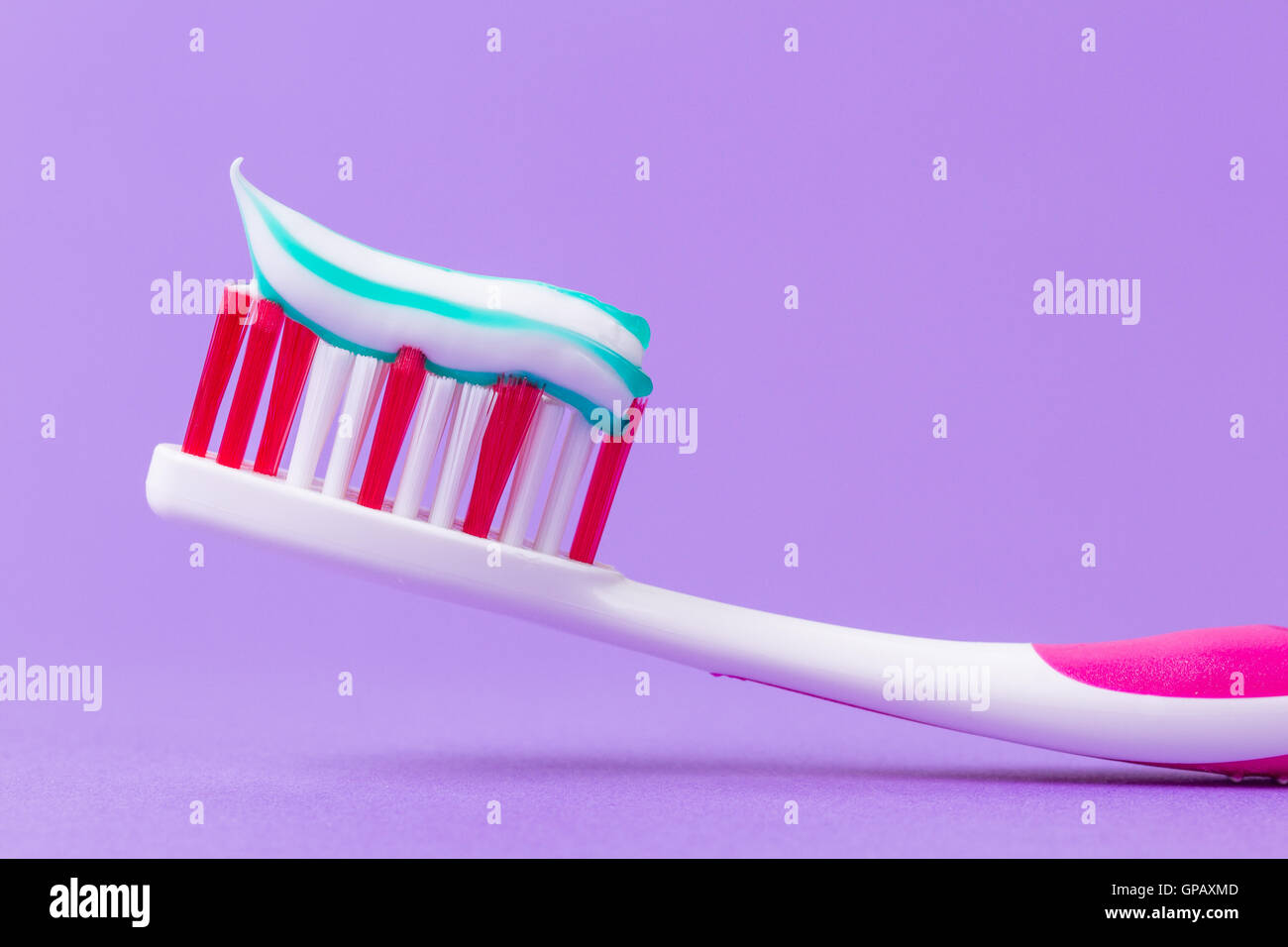A pink toothbrush with toothpaste Stock Photo Alamy