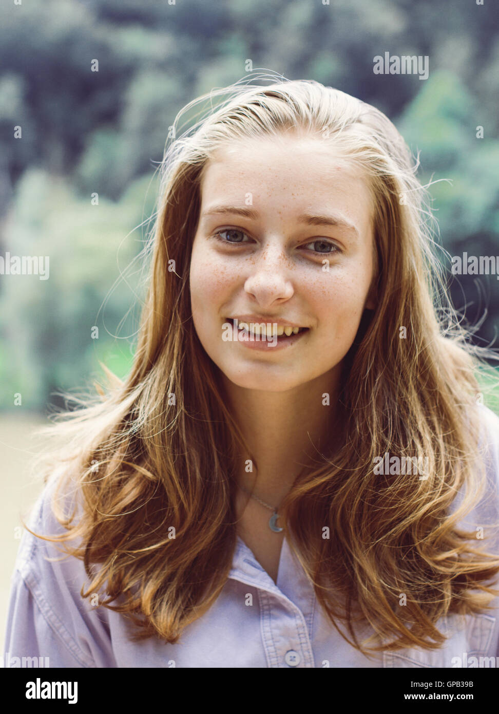 Cute teenage girl portrait with blond hair smiles Stock Photo