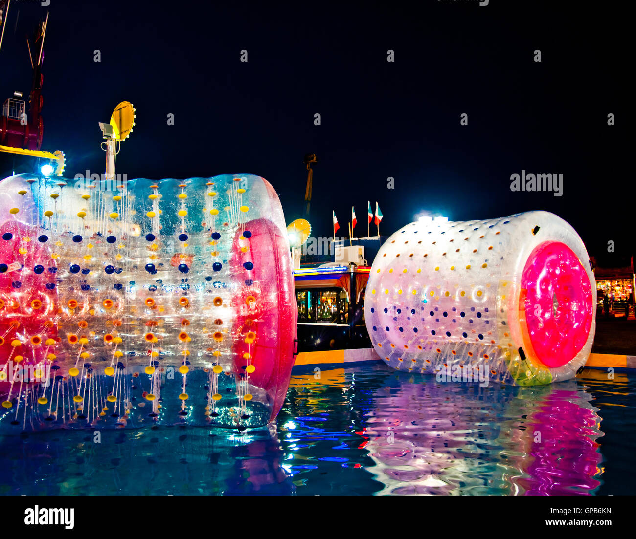 water ball to entertain children in an amusement park at night under a thousand colors of the lights of the games Stock Photo