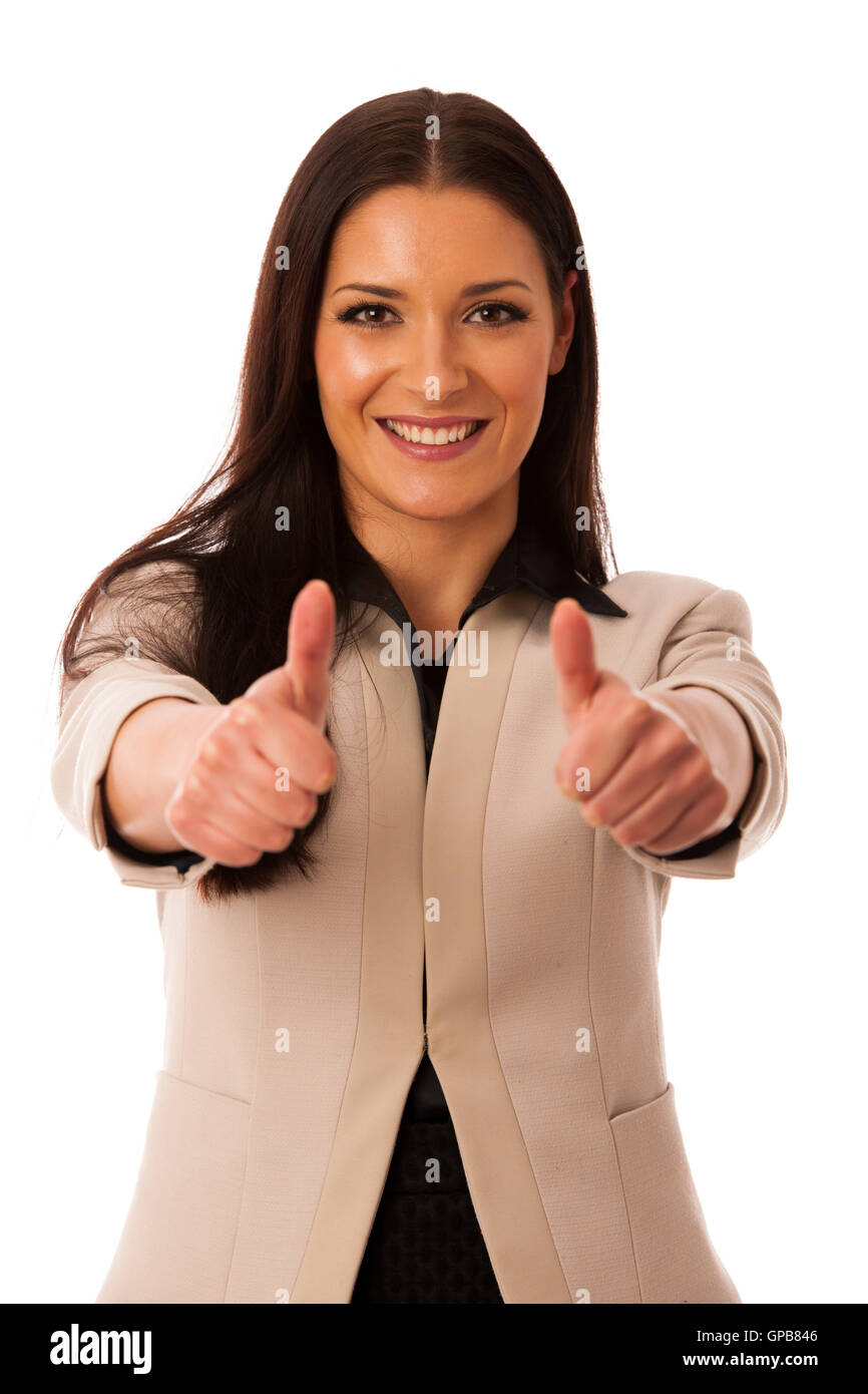 Woman gesturing success with thumbs up and big happy smile. Stock Photo