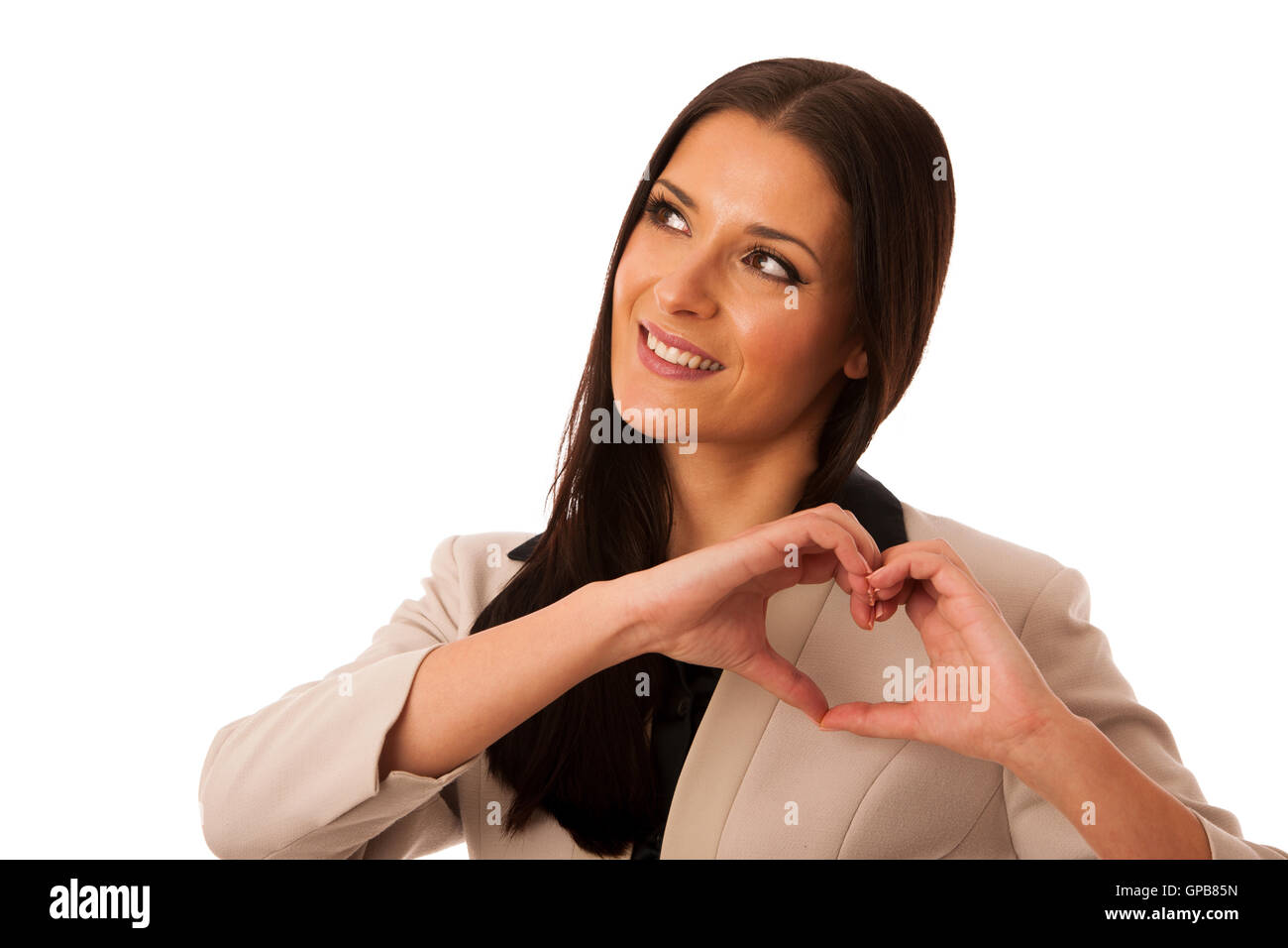 Woman gesturing love and passion with hands in heart shape. Body language of positive emotion. Stock Photo