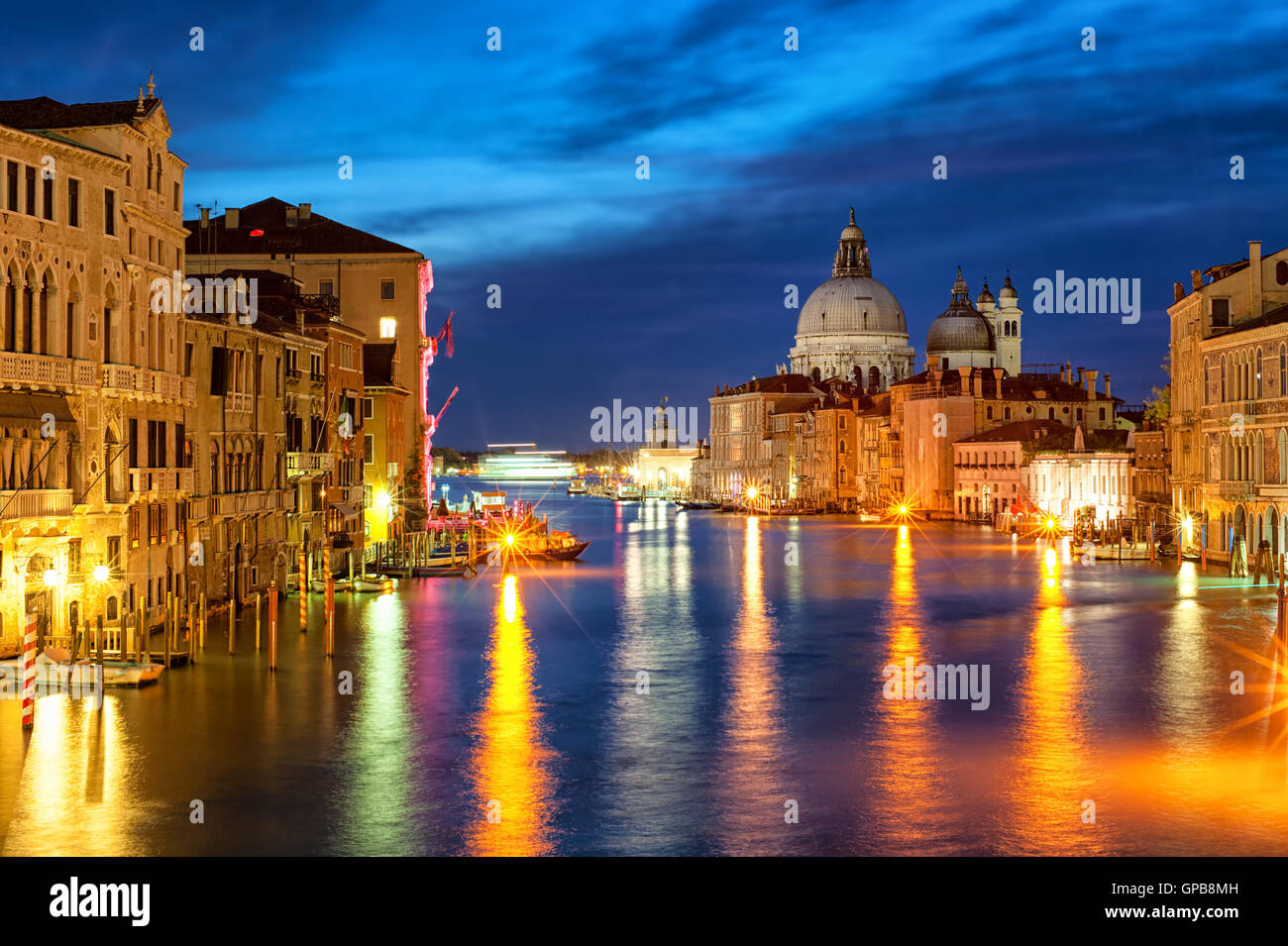 The Grand Canal and Santa Maria della Salute basilica, Venice, Italy, at night Stock Photo