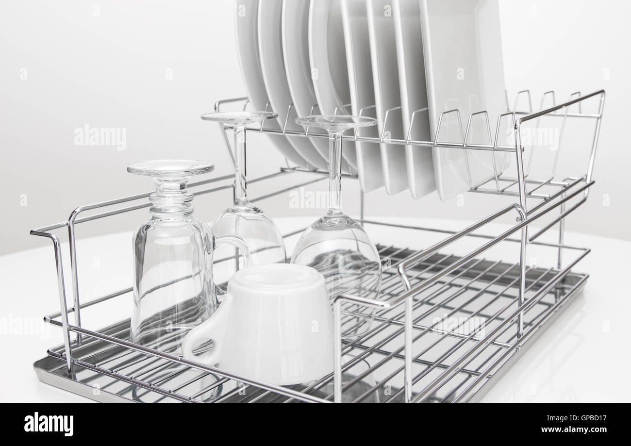 Metal dish rack with dishes and glasses Stock Photo Alamy