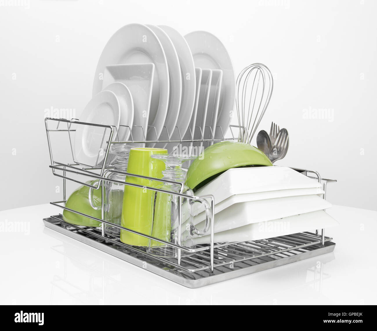 Bright dishes drying on metal dish rack Stock Photo Alamy