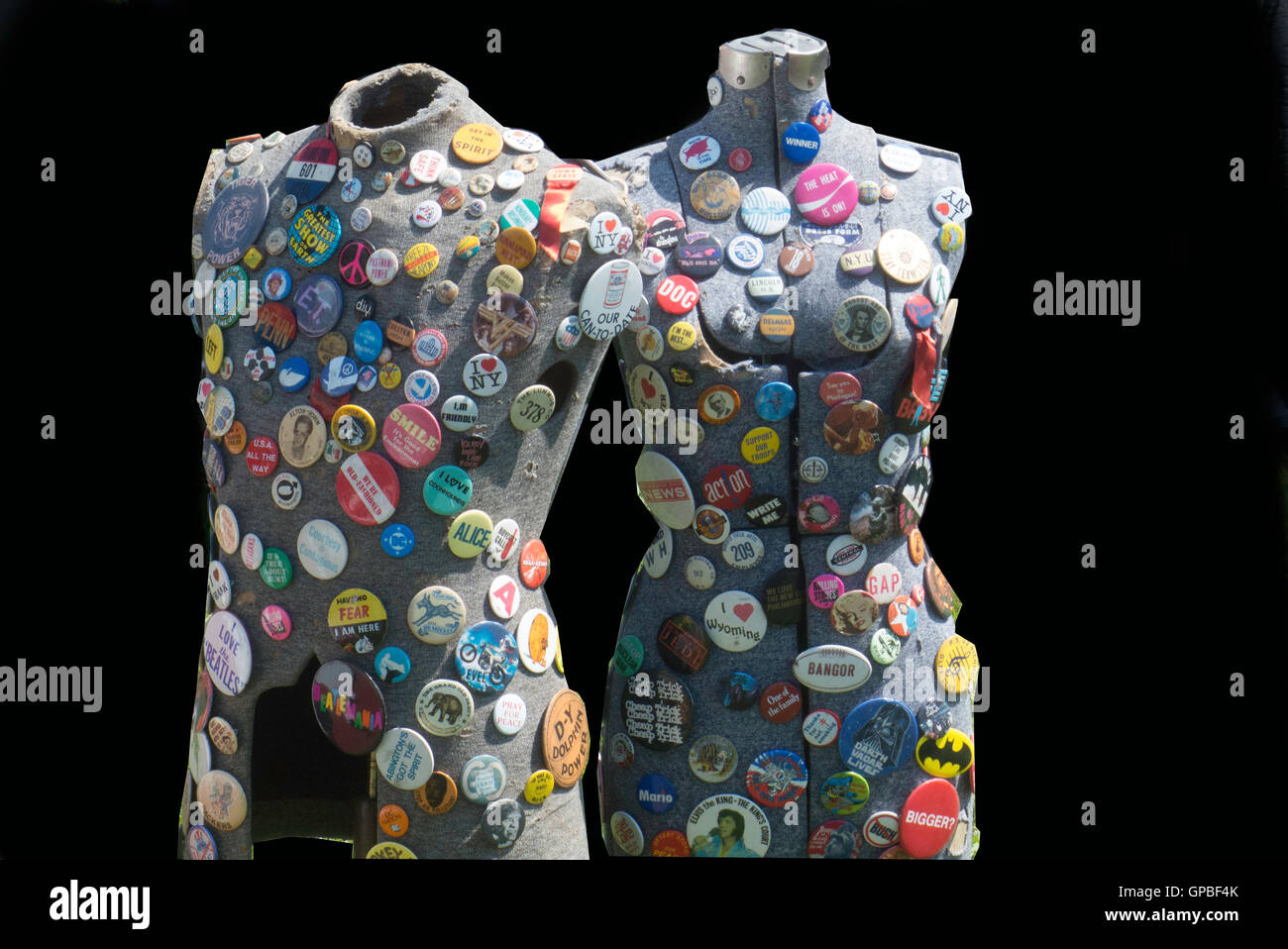 large number of buttons carrying variety of sayings placed on store mannequins Stock Photo