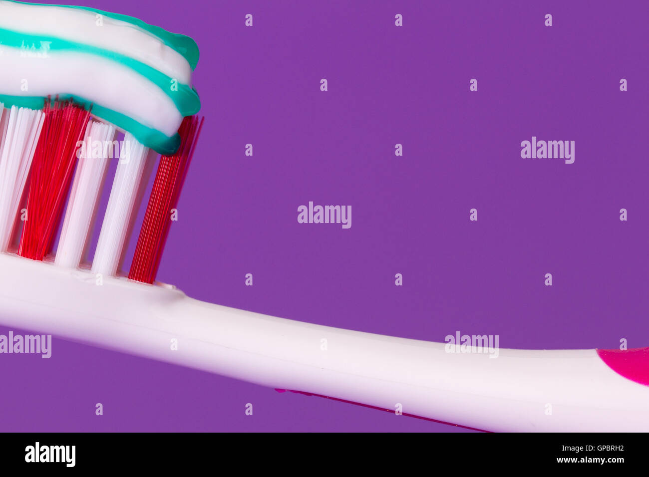 A pink toothbrush with toothpaste Stock Photo - Alamy
