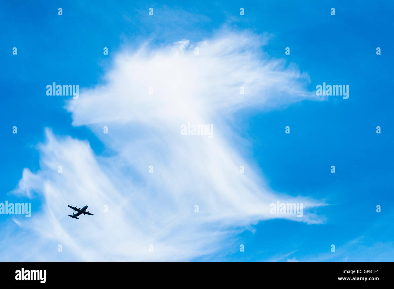 An airplane flying in the blue sky Stock Photo - Alamy