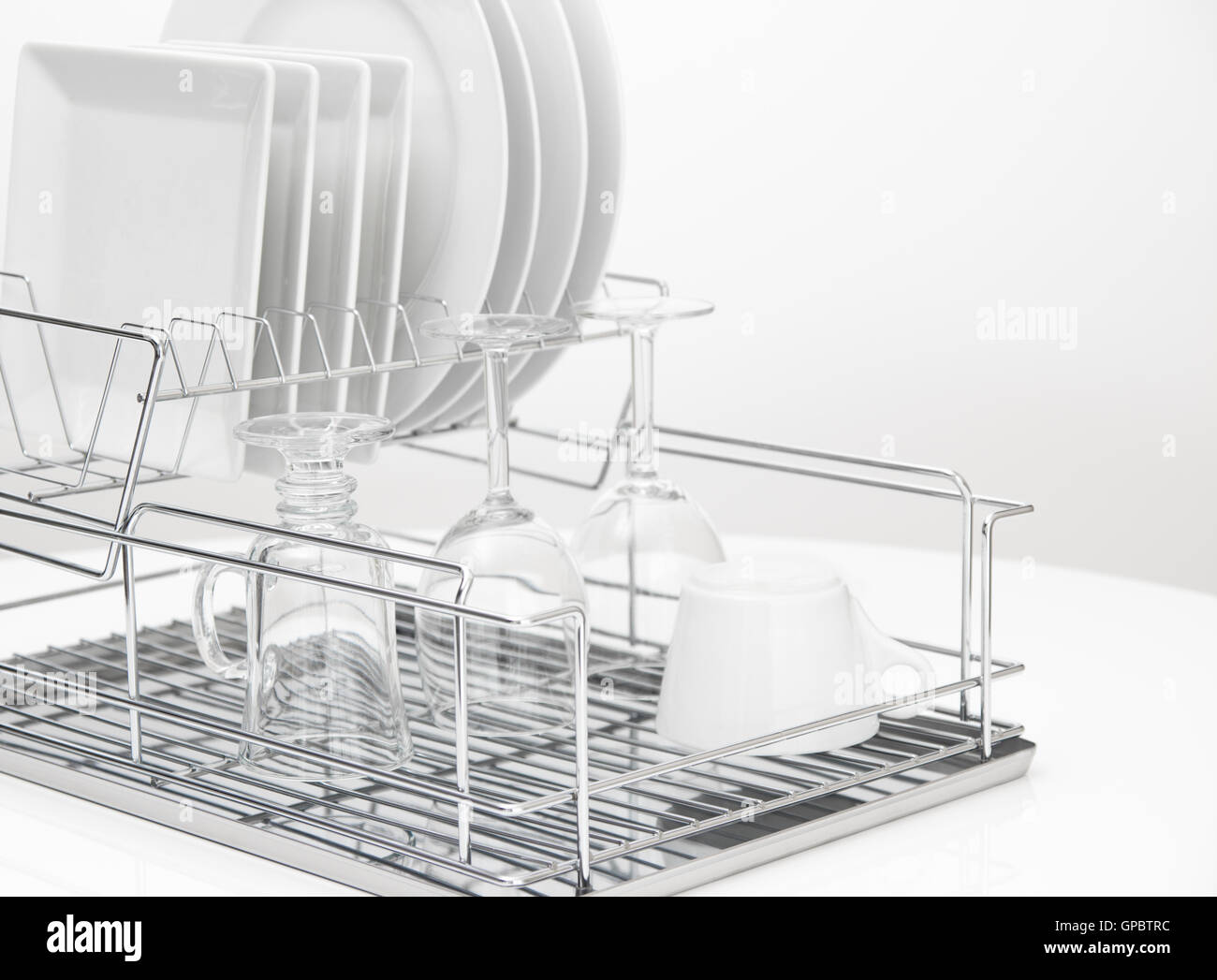 Dishes and glasses drying on metal dish rack Stock Photo Alamy