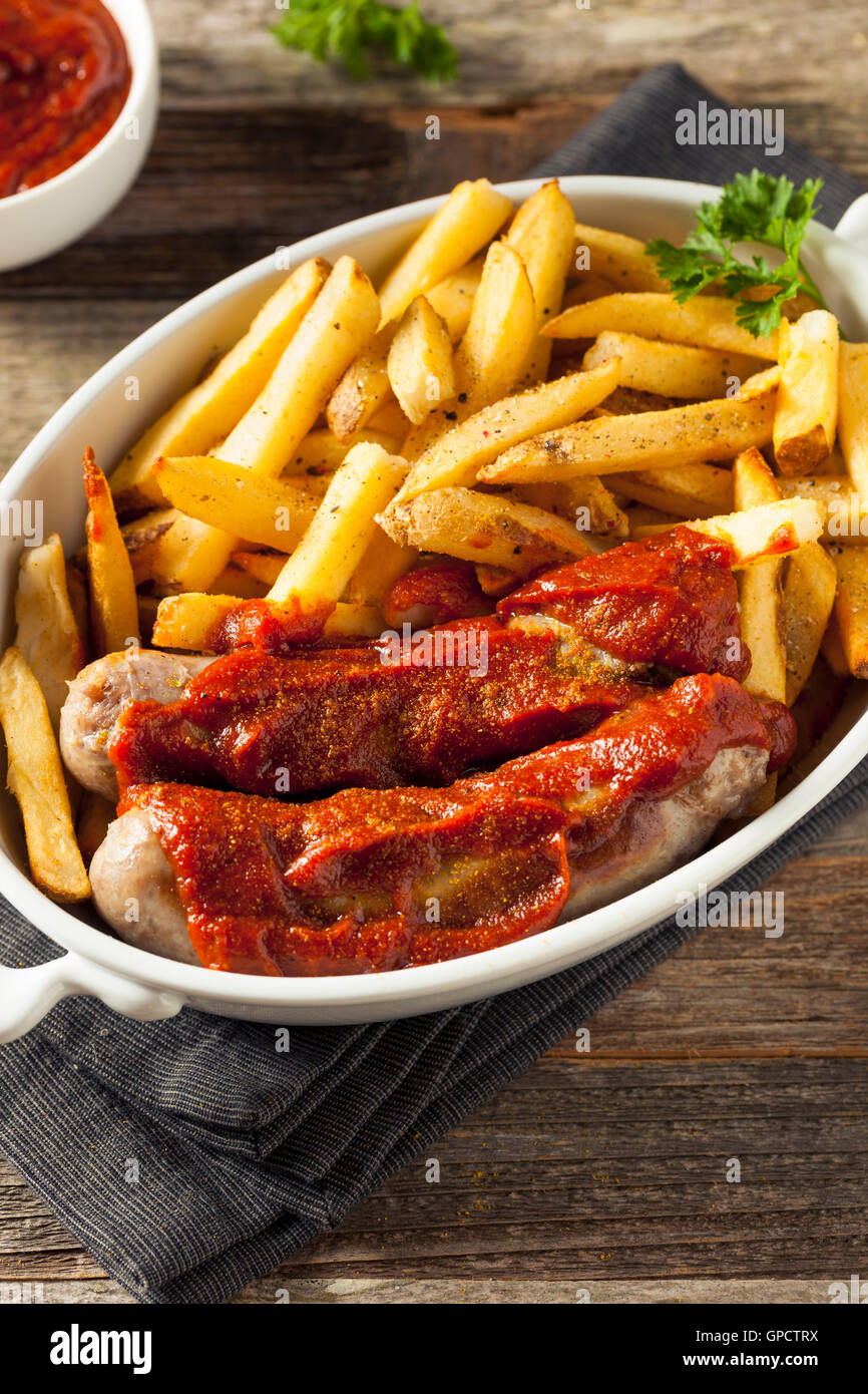 Homemade Currywurst and French Fries in a Bowl Stock Photo
