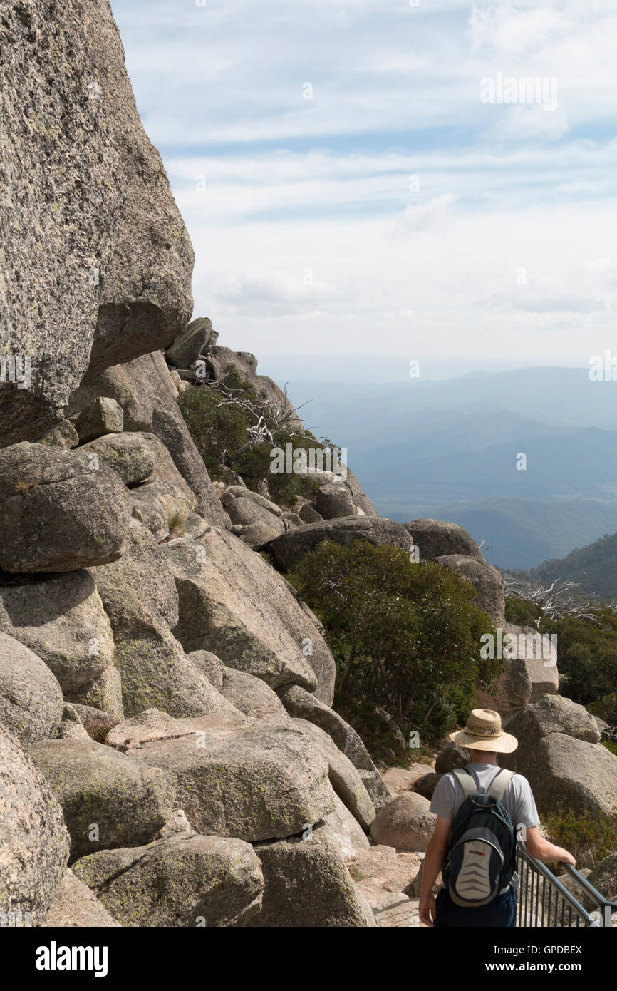 Man hiking down from The Horn at the peak of Mount Buffalo Stock Photo