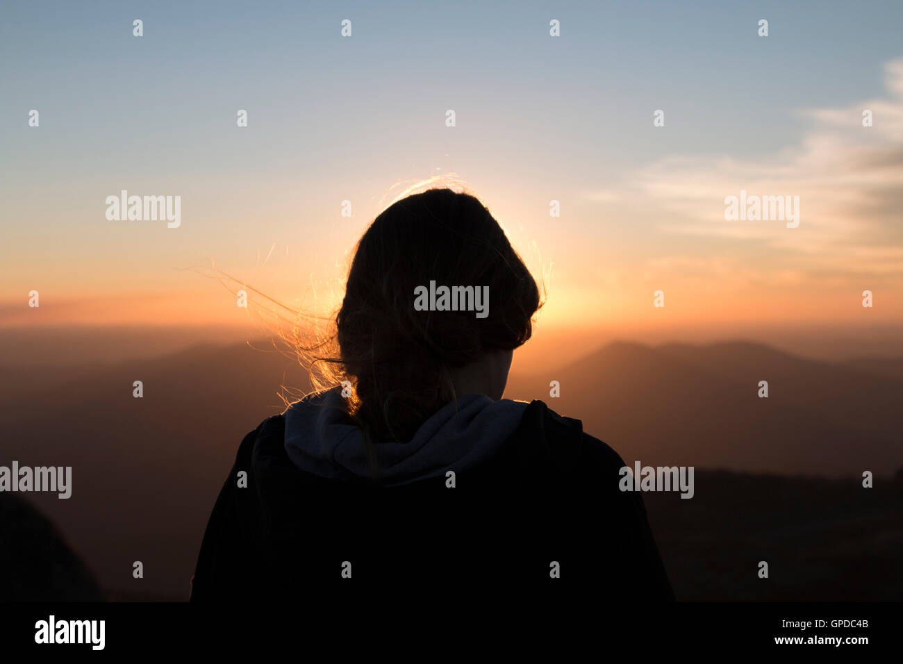 Girl watching the sunset on top of Mount Buffalo Stock Photo