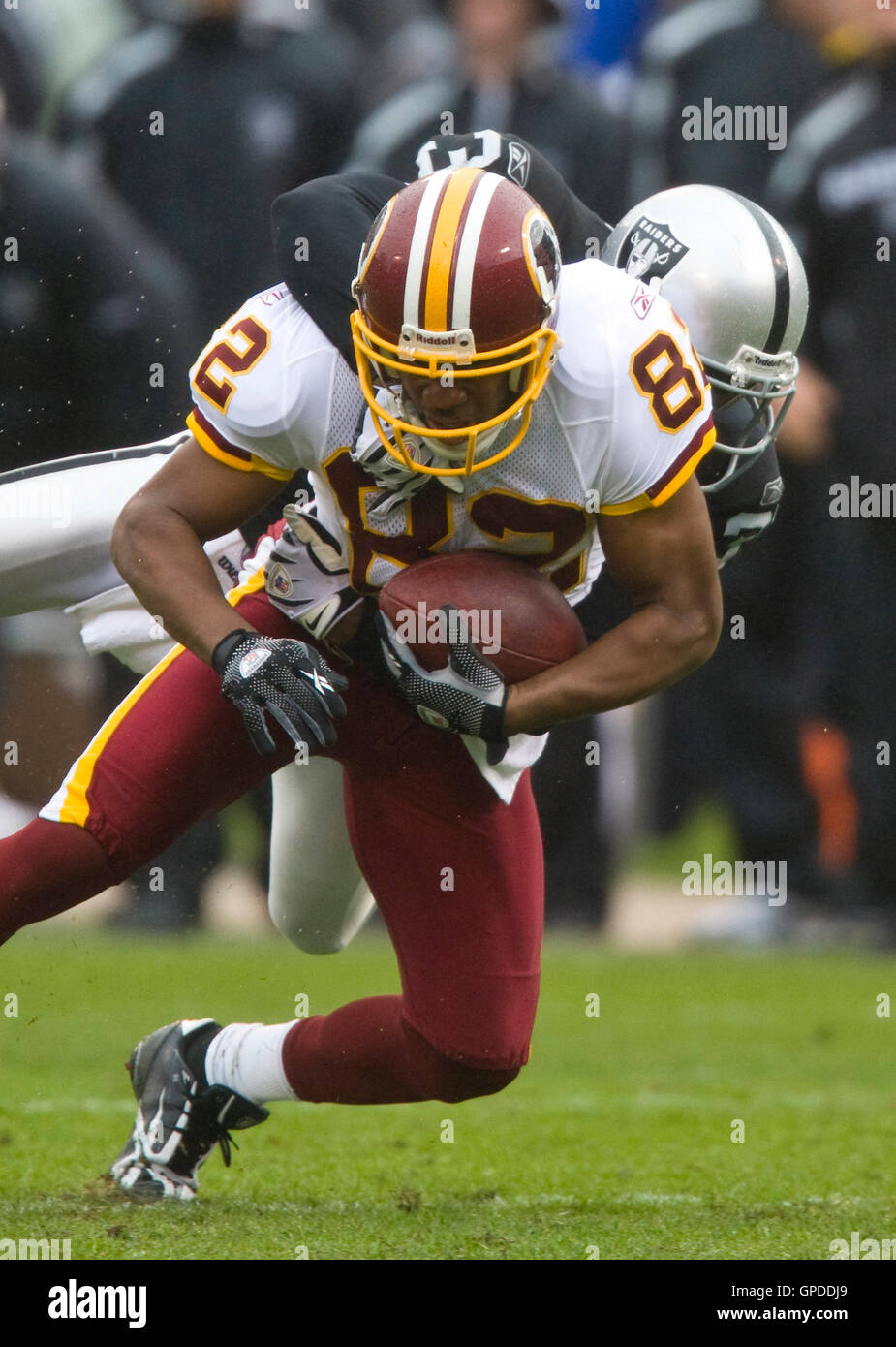 December 13, 2009; Oakland, CA, USA;  Oakland Raiders cornerback Hiram Eugene (31) tackles Washington Redskins wide receiver Antwaan Randle El (82) during the second quarter at Oakland-Alameda County Coliseum.  Washington defeated Oakland 34-13. Stock Photo