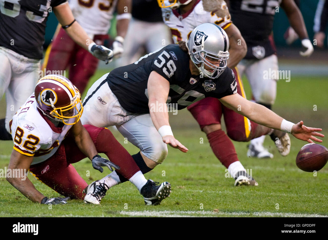 December 13, 2009; Oakland, CA, USA;  Oakland Raiders long snapper Jon Condo (59) reaches for a fumbled ball from Washington Redskins wide receiver Antwaan Randle El (82) on a punt return during the fourth quarter at Oakland-Alameda County Coliseum.  Wash Stock Photo