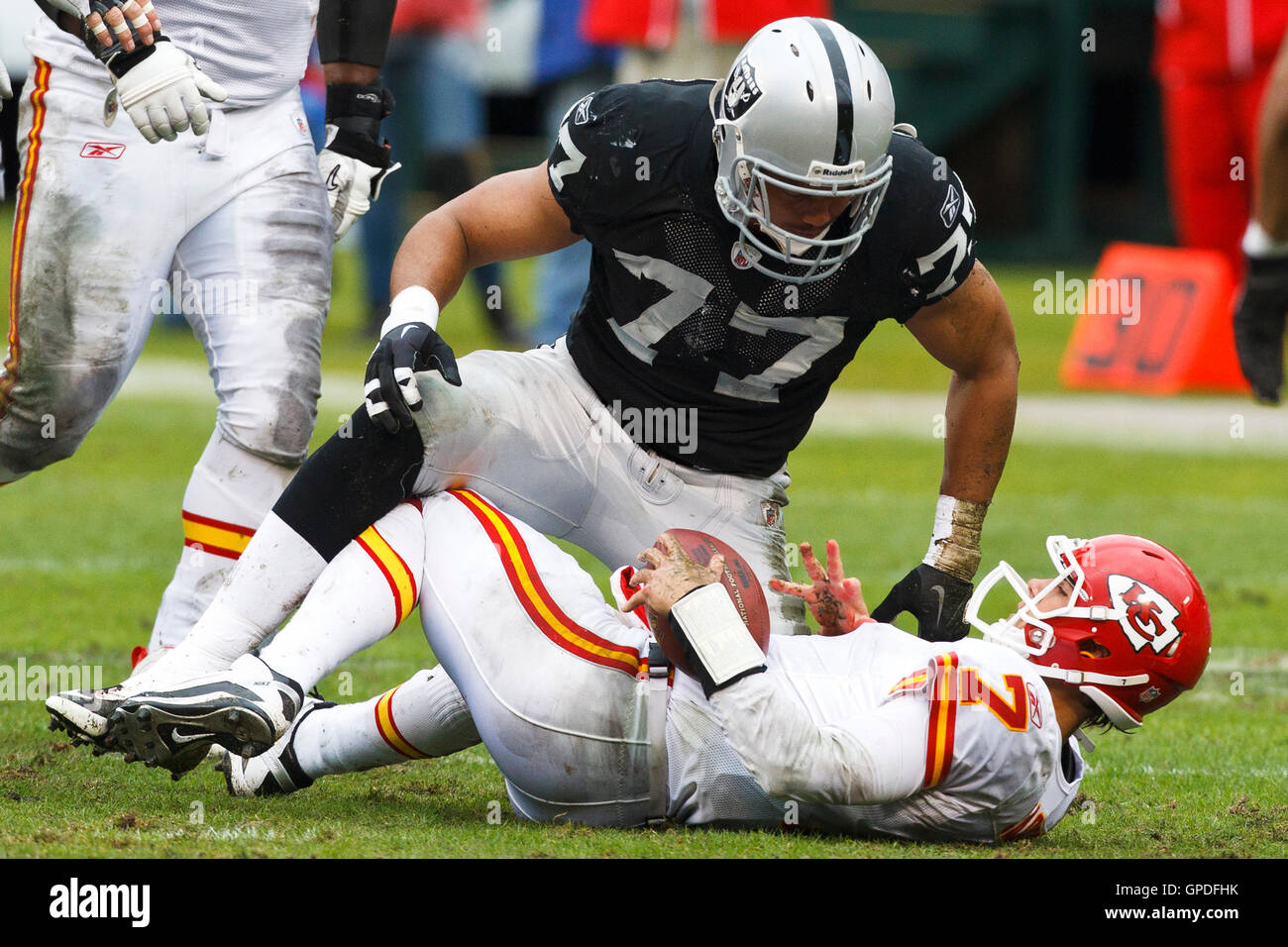 November 7, 2010; Oakland, CA, USA;  Oakland Raiders defensive end Matt Shaughnessy (77) tackles Kansas City Chiefs quarterback Matt Cassel (7) after a run during the first quarter at Oakland-Alameda County Coliseum. Stock Photo