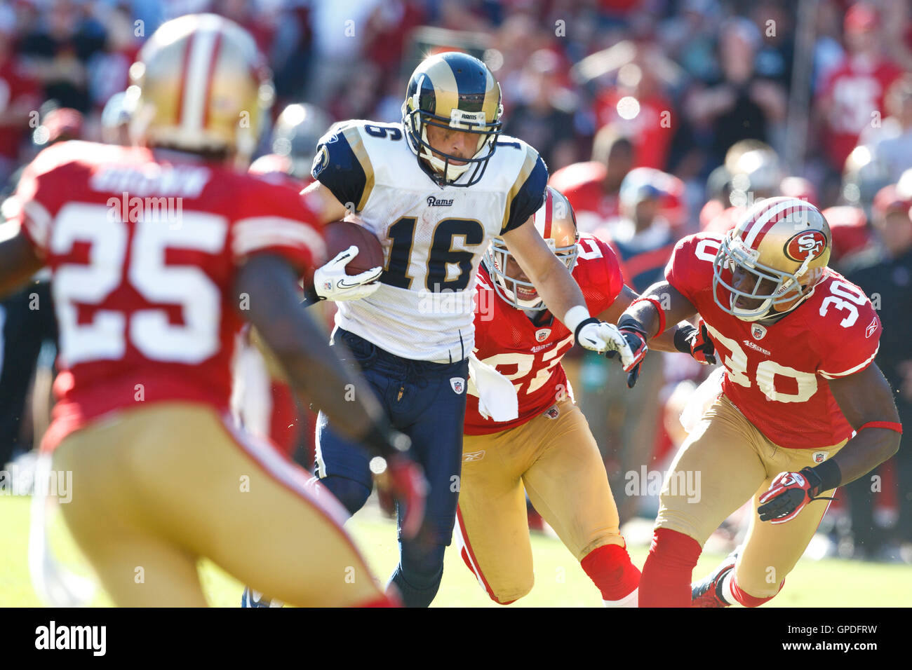 November 14, 2010; San Francisco, CA, USA;  St. Louis Rams wide receiver Danny Amendola (16) is pursued by San Francisco 49ers safety Reggie Smith (30) and cornerback Nate Clements (22) and cornerback Tarell Brown (25) during the second quarter at Candles Stock Photo