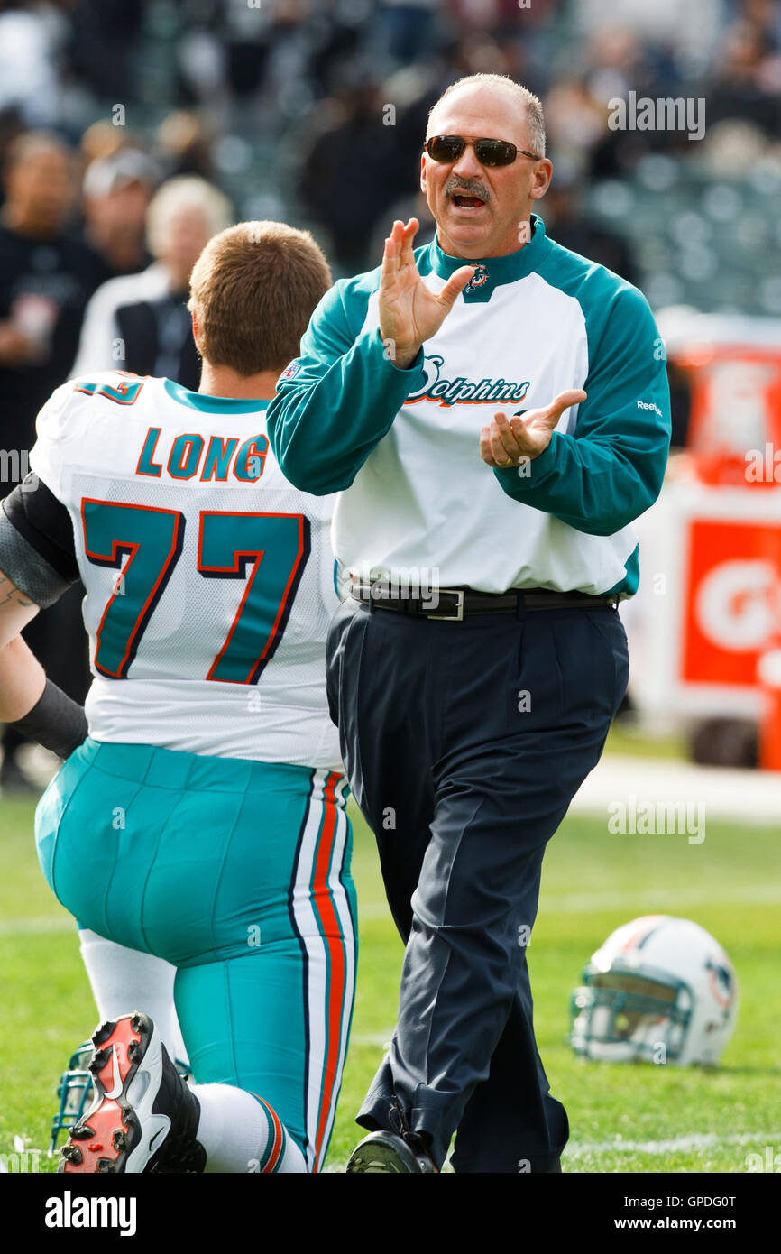 November 28, 2010; Oakland, CA, USA; Miami Dolphins head coach Tony Sparano  walks past offensive tackle Jake Long (77) before the game against the  Oakland Raiders at Oakland-Alameda County Coliseum Stock Photo - Alamy