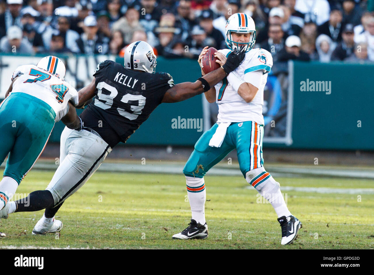 November 28, 2010; Oakland, CA, USA;  Miami Dolphins quarterback Chad Henne (7) is sacked by Oakland Raiders defensive tackle Tommy Kelly (93) during the third quarter at Oakland-Alameda County Coliseum. Stock Photo