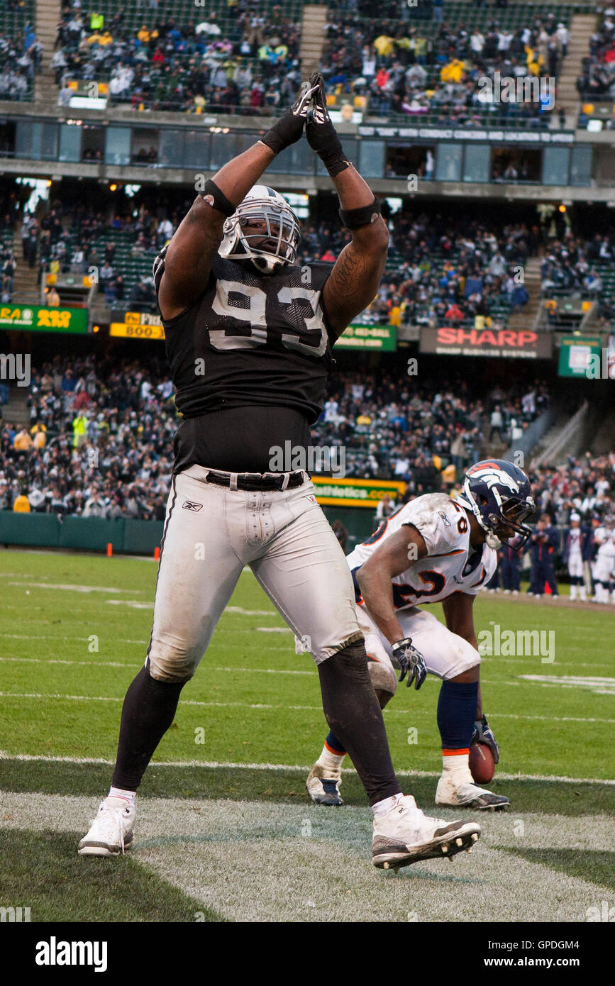 December 19, 2010; Oakland, CA, USA;  Oakland Raiders defensive tackle Tommy Kelly (93) celebrates after his team tackled Denver Broncos running back Correll Buckhalter (back) for a safety during the fourth quarter at Oakland-Alameda County Coliseum. Oakl Stock Photo