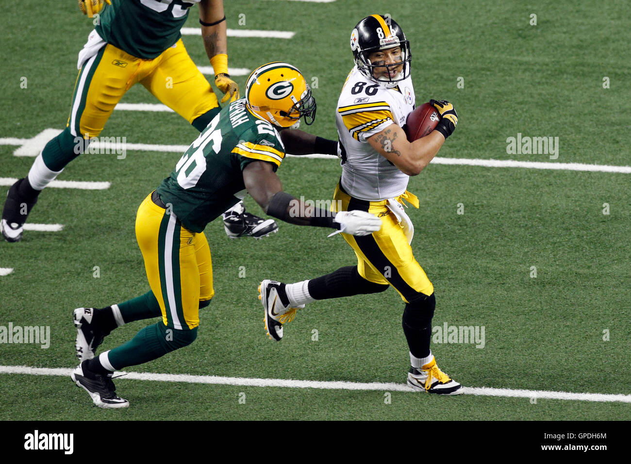 Feb 6, 2011; Arlington, TX, USA; Pittsburgh Steelers wide receiver Hines Ward (86) is tackled by Green Bay Packers safety Charlie Peprah (26) after a pass reception during the first half of Super Bowl XLV at Cowboys Stadium. Stock Photo