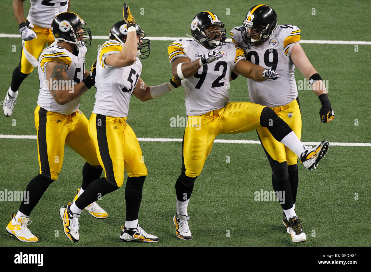 Feb 6, 2011; Arlington, TX, USA; Pittsburgh Steelers linebacker James Harrison (92) celebrates with defensive end Brett Keisel (99) and linebacker James Farrior (51) and linebacker LaMarr Woodley (left)after sacking Green Bay Packers quarterback Aaron Rod Stock Photo
